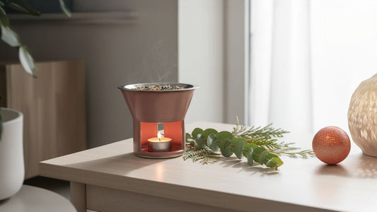 Clean incense warmer with tealight candle on light wood surface.