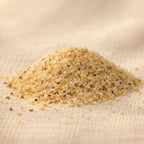 Fine Boswellia sacra frankincense sand granules on a neutral fabric surface