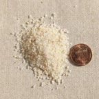 Close-up of Omani frankincense sand beside a penny