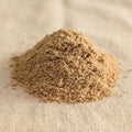 Extra-fine Santalum album sandalwood balloon dust on a neutral fabric surface