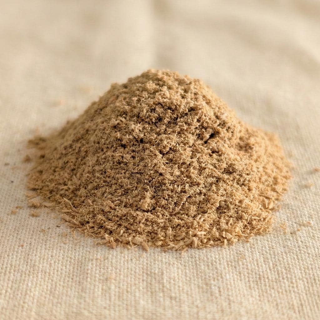 Extra-fine Santalum album sandalwood balloon dust on a neutral fabric surface