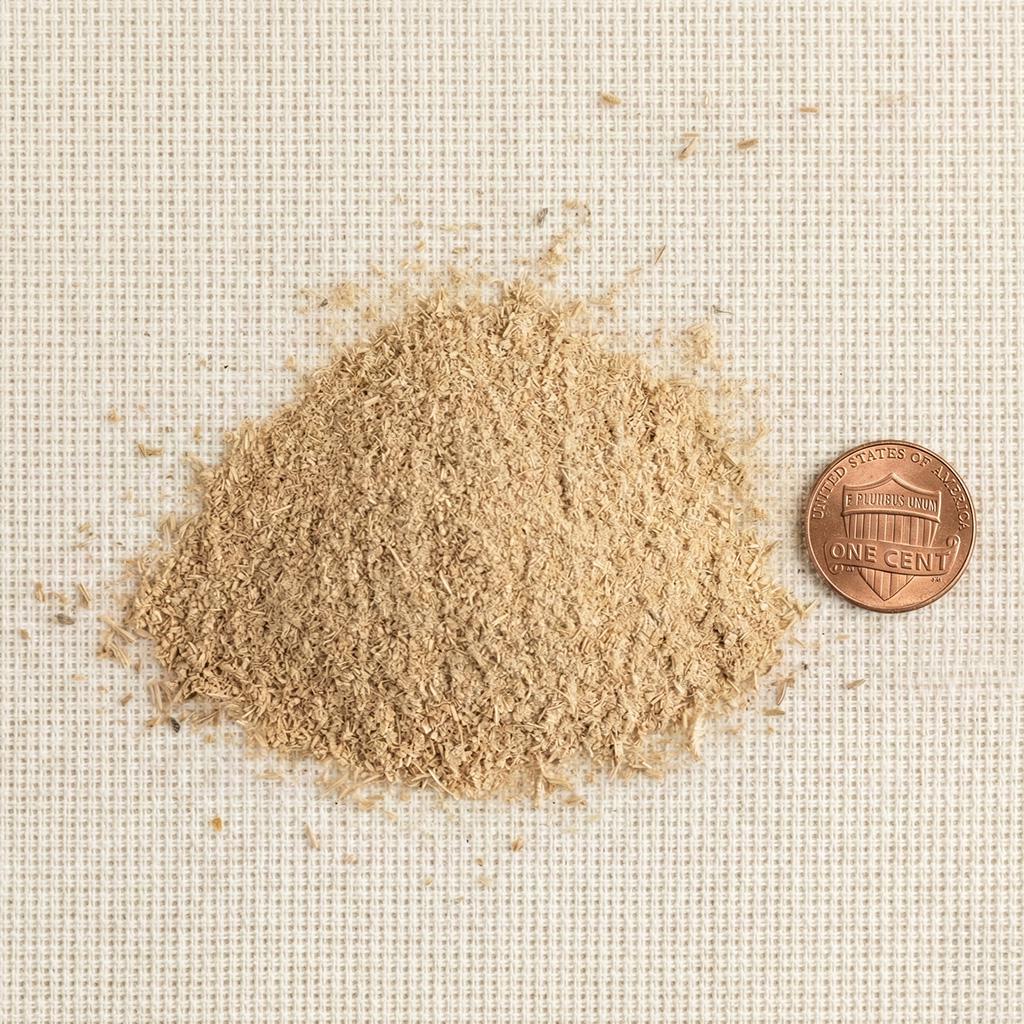Sandalwood balloon dust beside a penny for particle-size reference