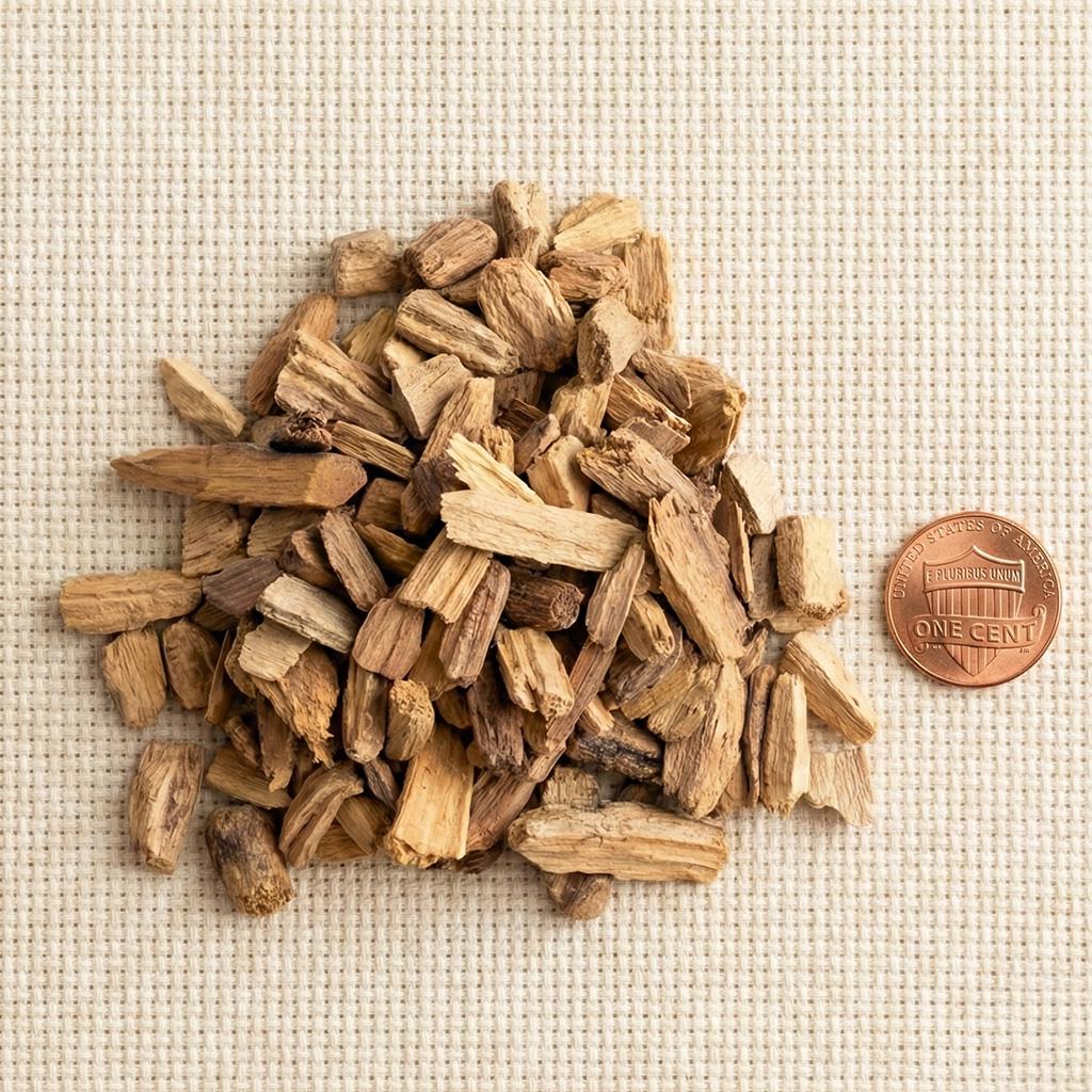 Palo Santo wood chips beside a penny for size reference